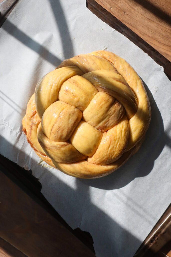 unbaked challah loaf braid into a knot