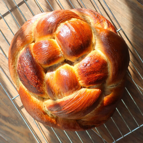 baked spiced challah bread cooling on wire rack