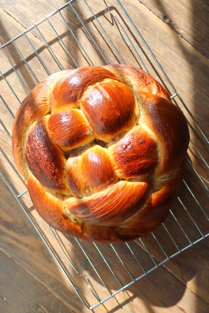 baked spiced challah bread cooling on wire rack