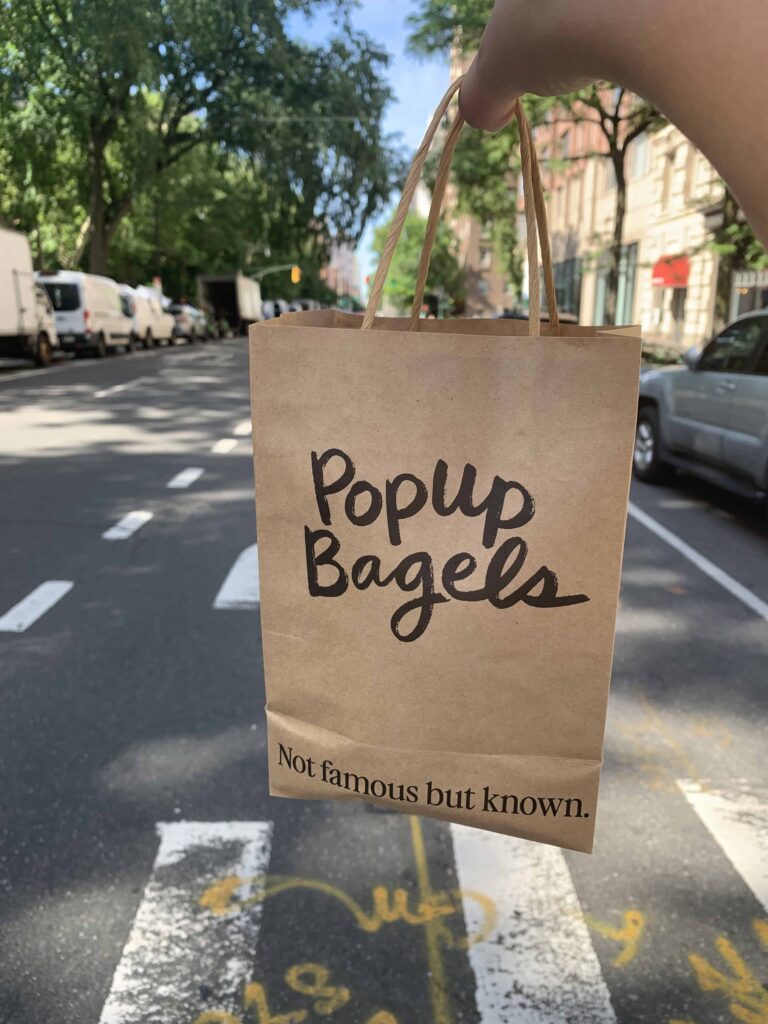 carrying bag of popup bagels in upper west side neighborhood