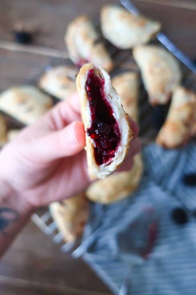 inside of flaky hand pie with blackberry filling