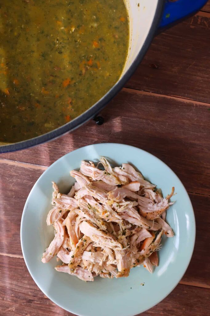 shredded chicken next to bowl of soup