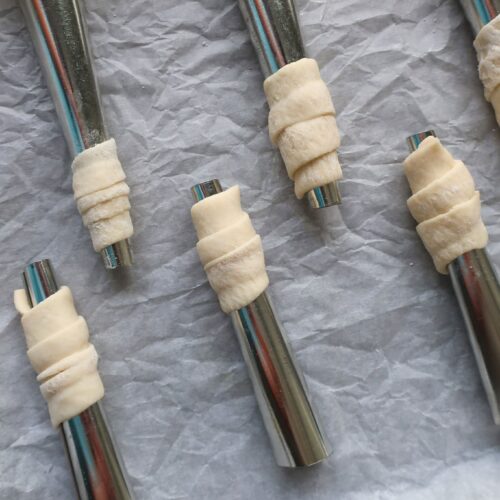 puff pastry dough wrapped around rods for lady lock recipe
