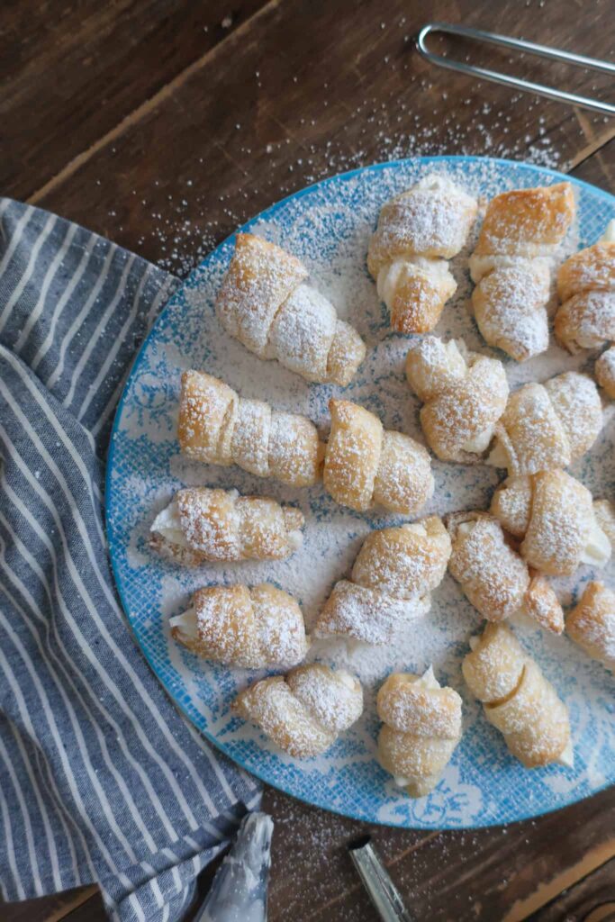 mini cream horns on blue plate
