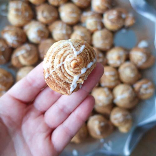 holding a mini puff pastry cinnamon rolls
