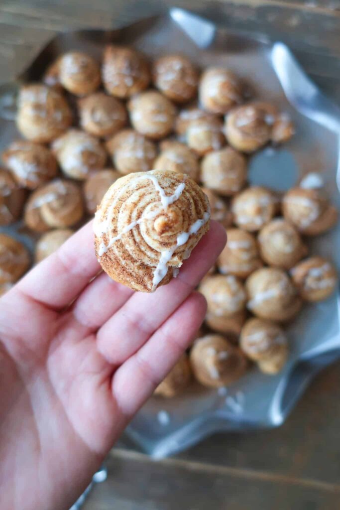 holding a mini puff pastry cinnamon rolls
