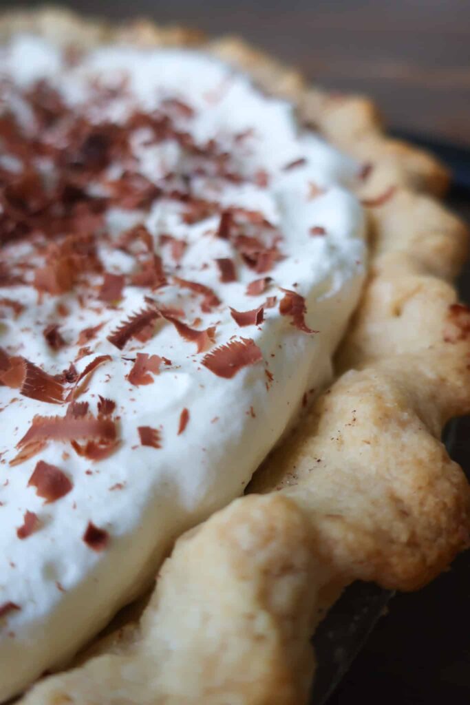 fluffy whipped cream on pie with chocolate shavings