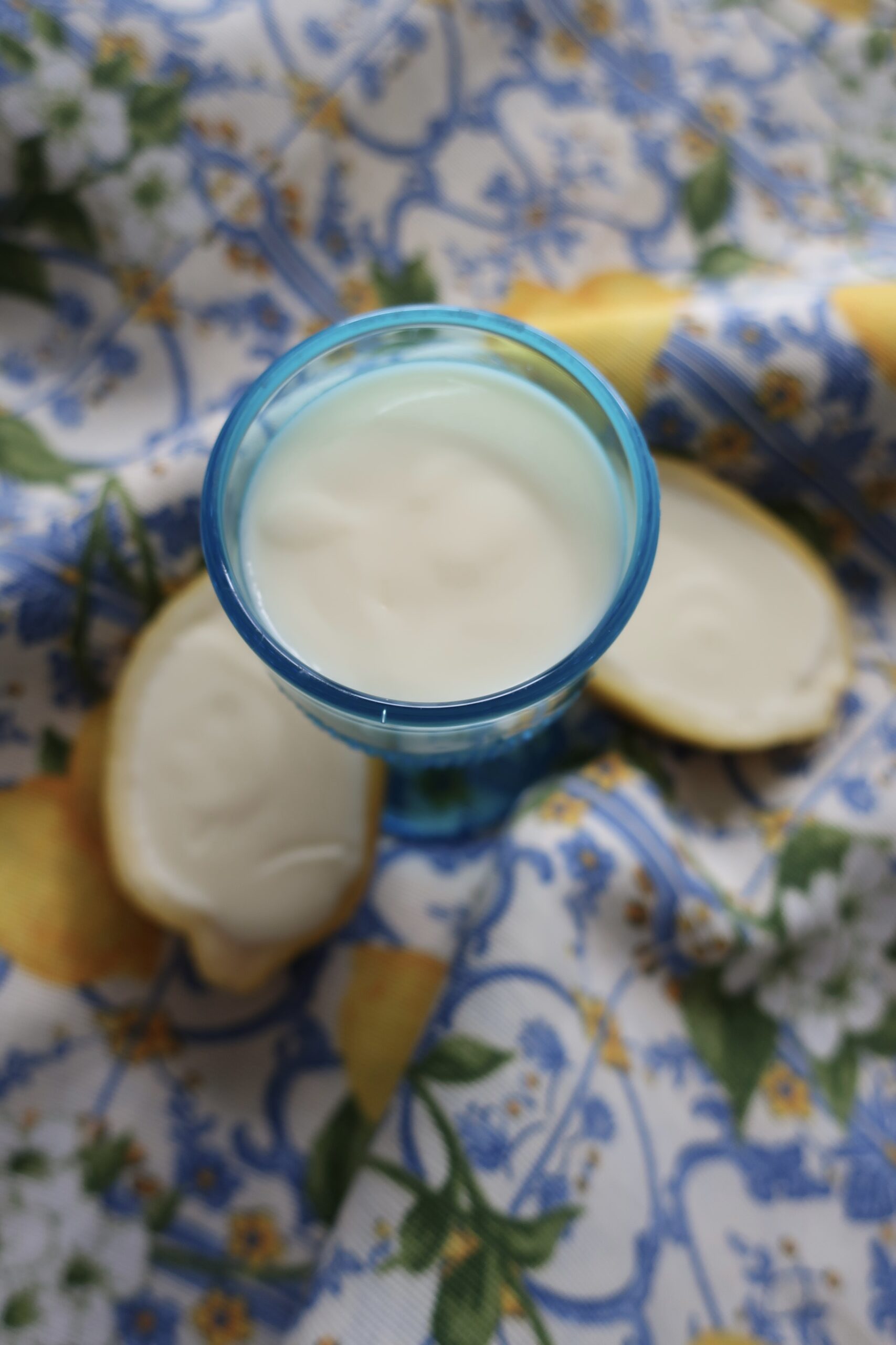 lemon posset; lemon posset in halves of lemon; lemon posset in blue small chalice on striped napkin