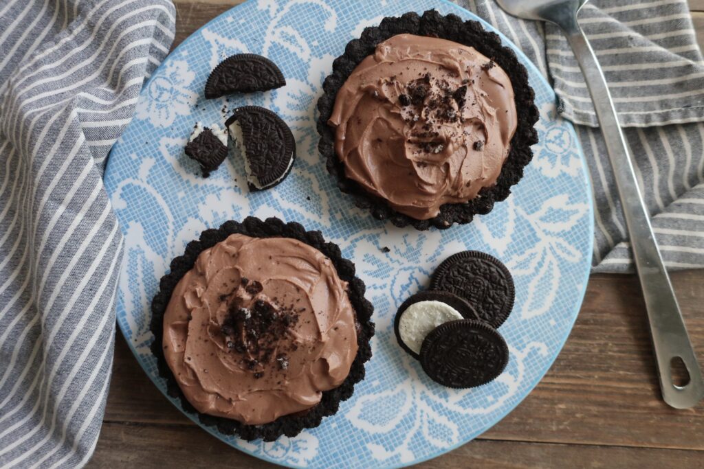 triple chocolate brownie pies with oreo crust, double chocolate brownies, and whipped milk chocolate ganache