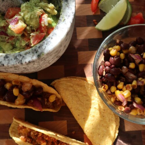 quinoa taco meat for vegan quinoa taco meat with homemade cashew sour cream, and homemade guacamole; guacamole in mortar and pestle