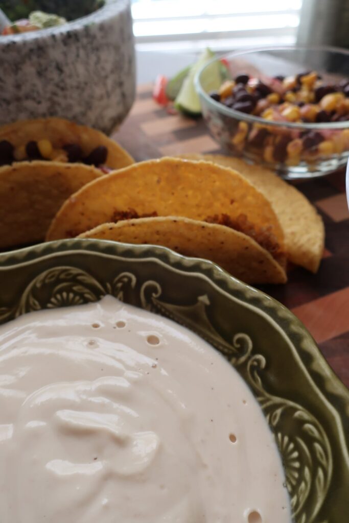 quinoa taco meat for vegan quinoa taco meat with homemade cashew sour cream, and homemade guacamole; guacamole in mortar and pestle