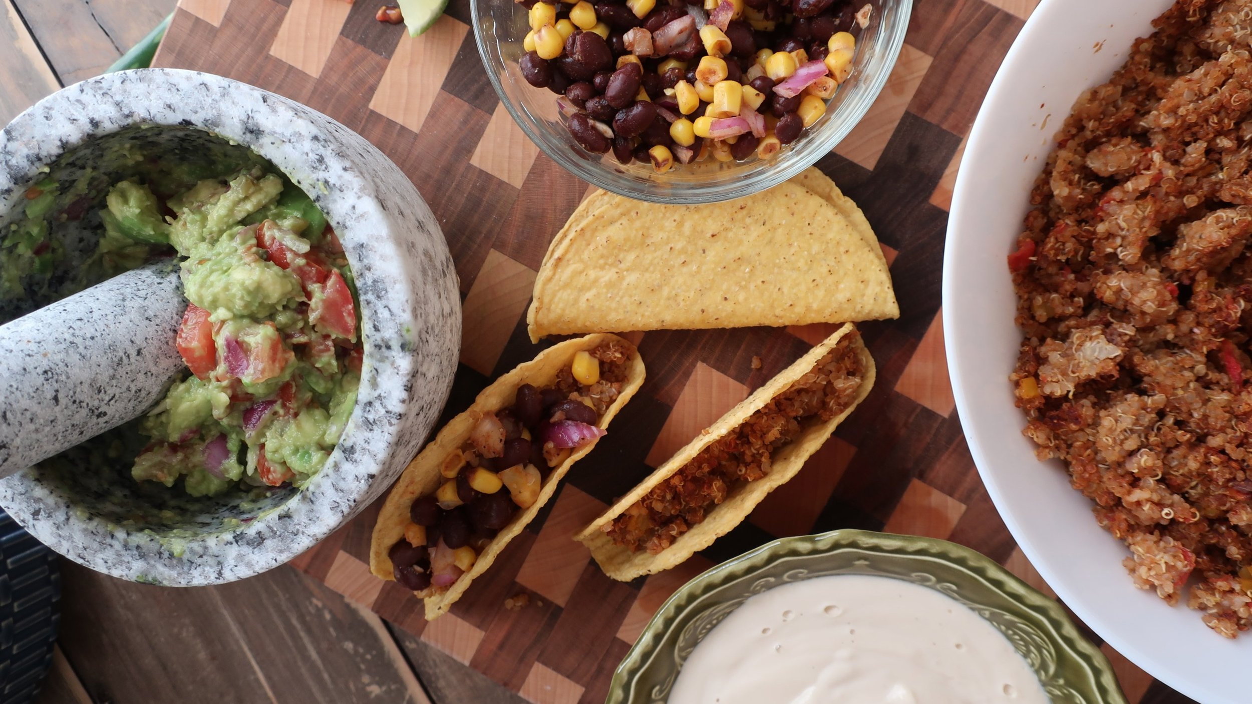 quinoa taco meat for vegan quinoa taco meat with homemade cashew sour cream, and homemade guacamole; guacamole in mortar and pestle