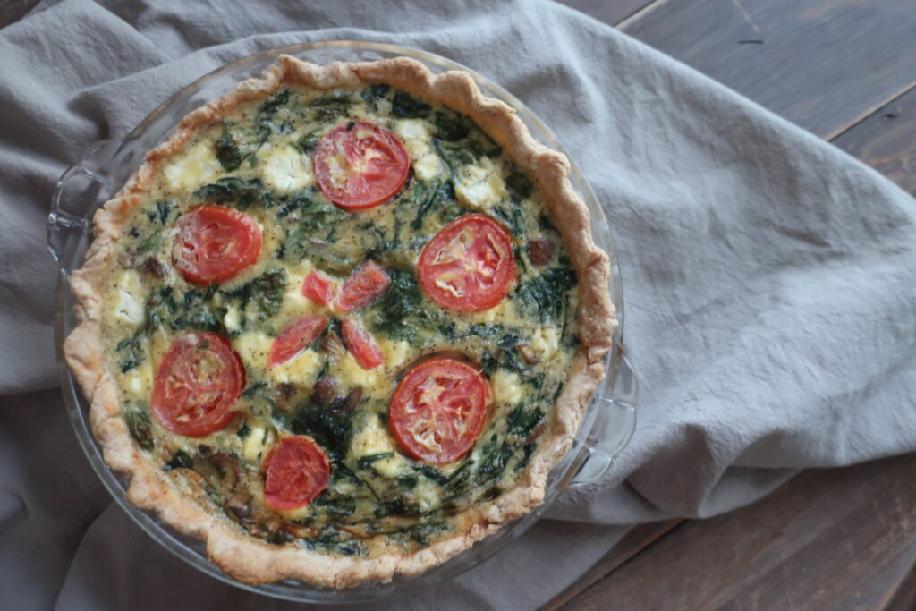 veggie quiche with shortcrust pastry; spinach, goat cheese, feta, tomato, spinach quiche in shortcrust pastry