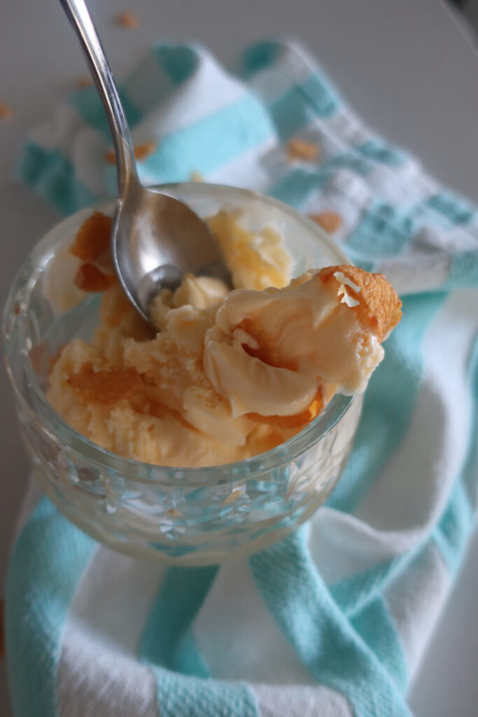 dish of cereal milk ice cream topped with cornflakes