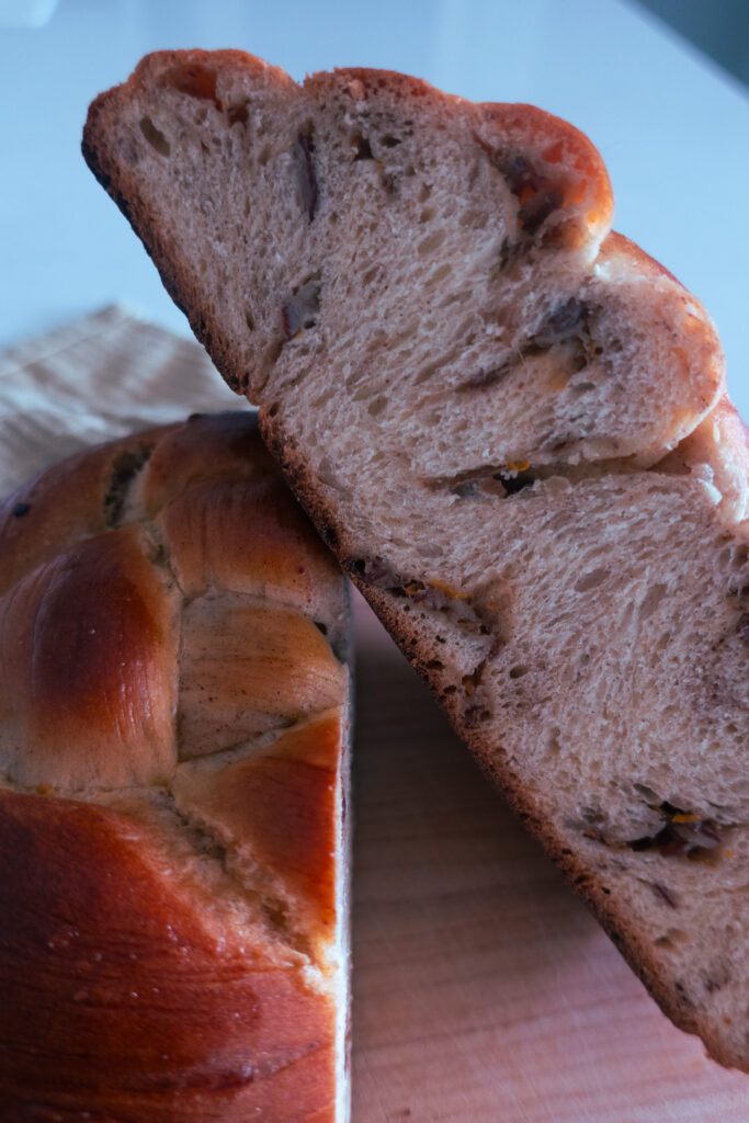 sliced, inside look at spiced challah bread knot; cardamom, cinnamon, date spiced enriched dough