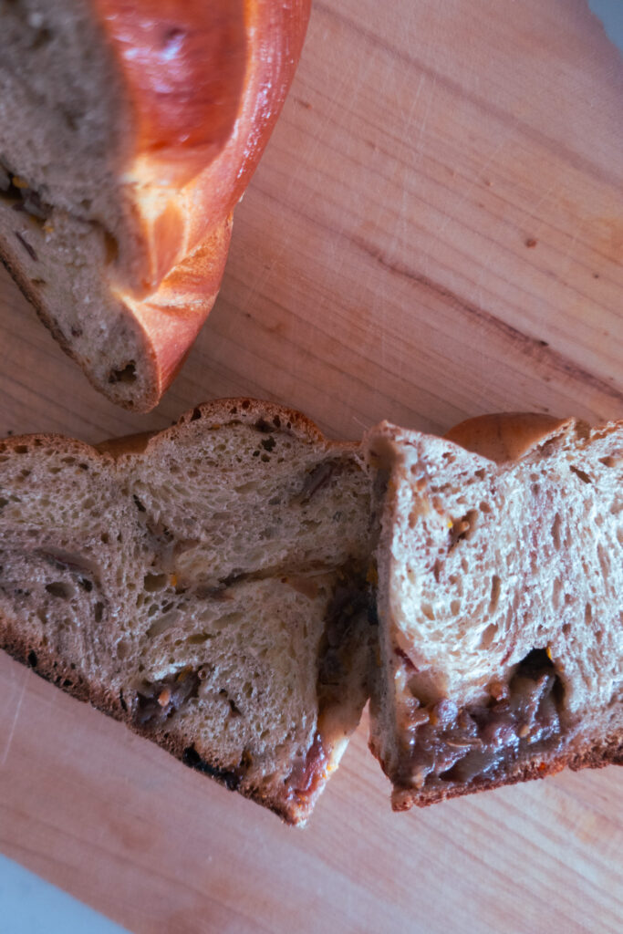 sliced, inside look at spiced challah bread knot; cardamom, cinnamon, date spiced enriched dough