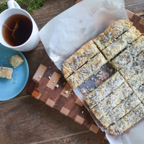 rosemary shortbread topped with rosemary sugar with a cup of tea