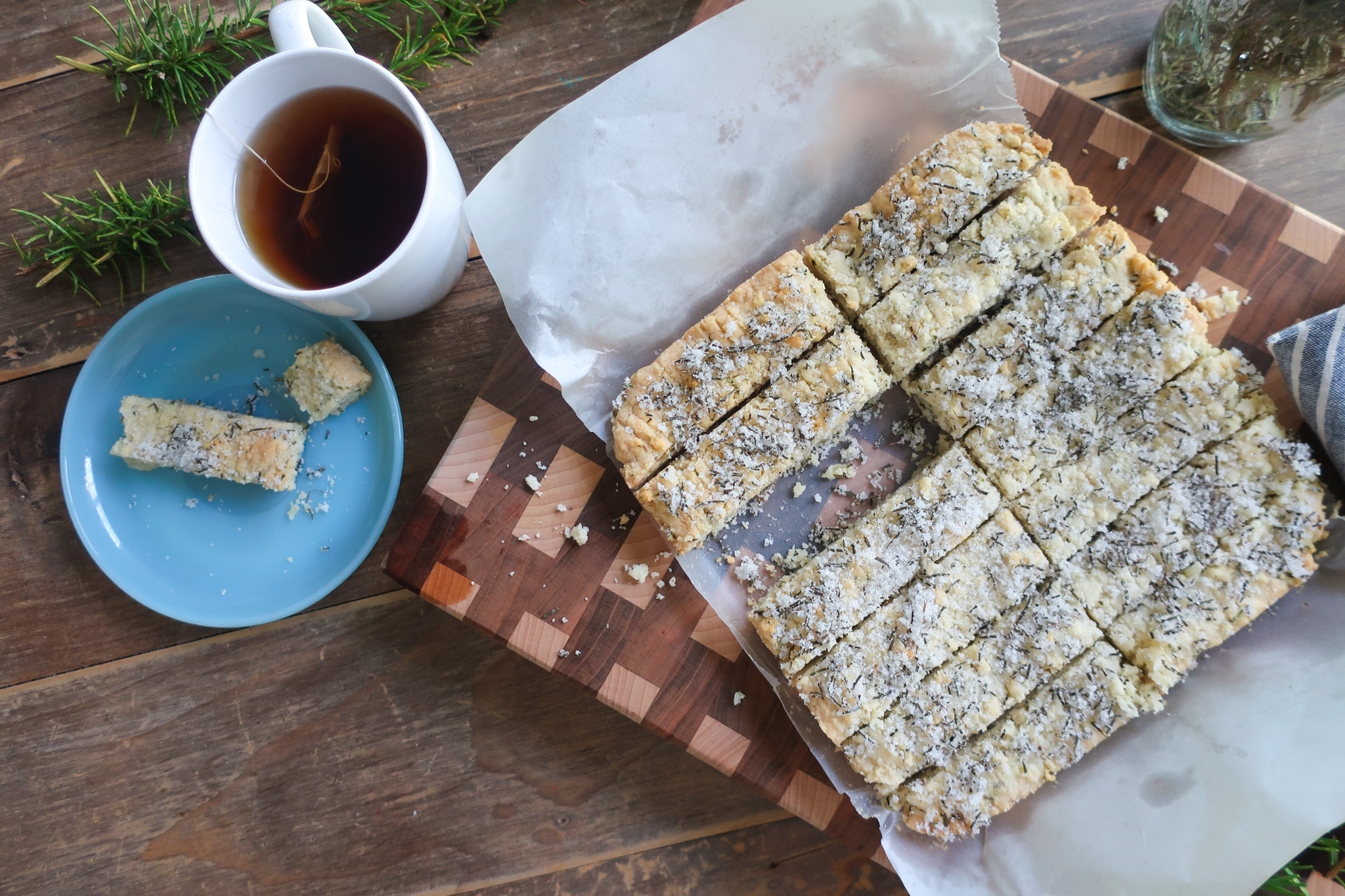 rosemary shortbread topped with rosemary sugar with a cup of tea