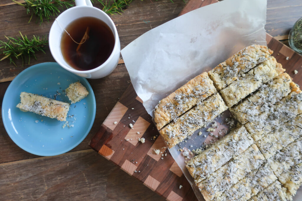 rosemary shortbread topped with rosemary sugar with a cup of tea