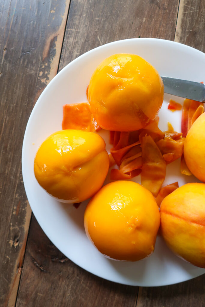 bowl of blanched and peeled peaches for peach and mint compote