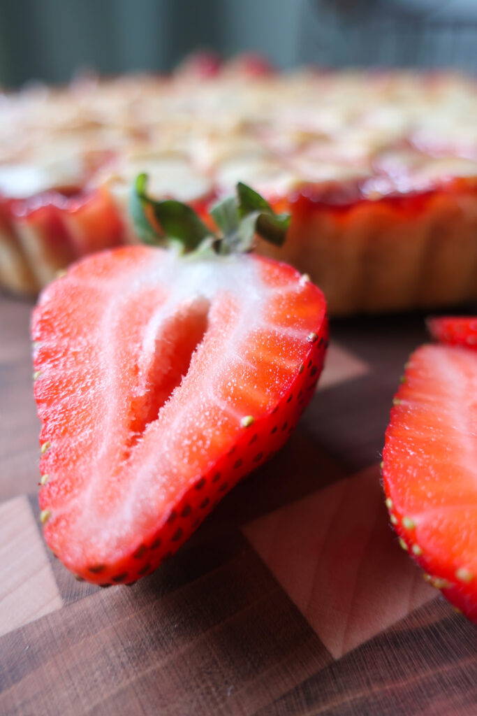 fresh strawberry next to strawberry basil tart; strawberry basil pie