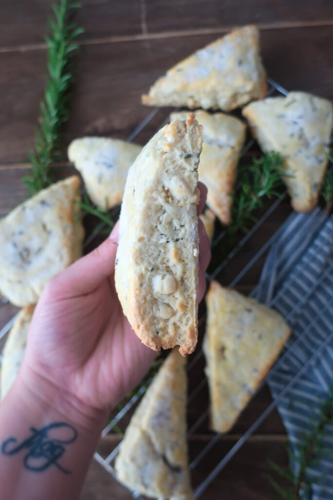 rosemary white chocolate scones with rosemary sugar; side view of white chocolate rosemary scones with chunks of white chocolate