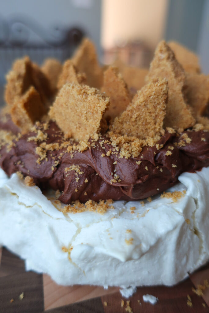 s'mores pavlova with french meringue, dark chocolate ganache, and graham cracker crust topping