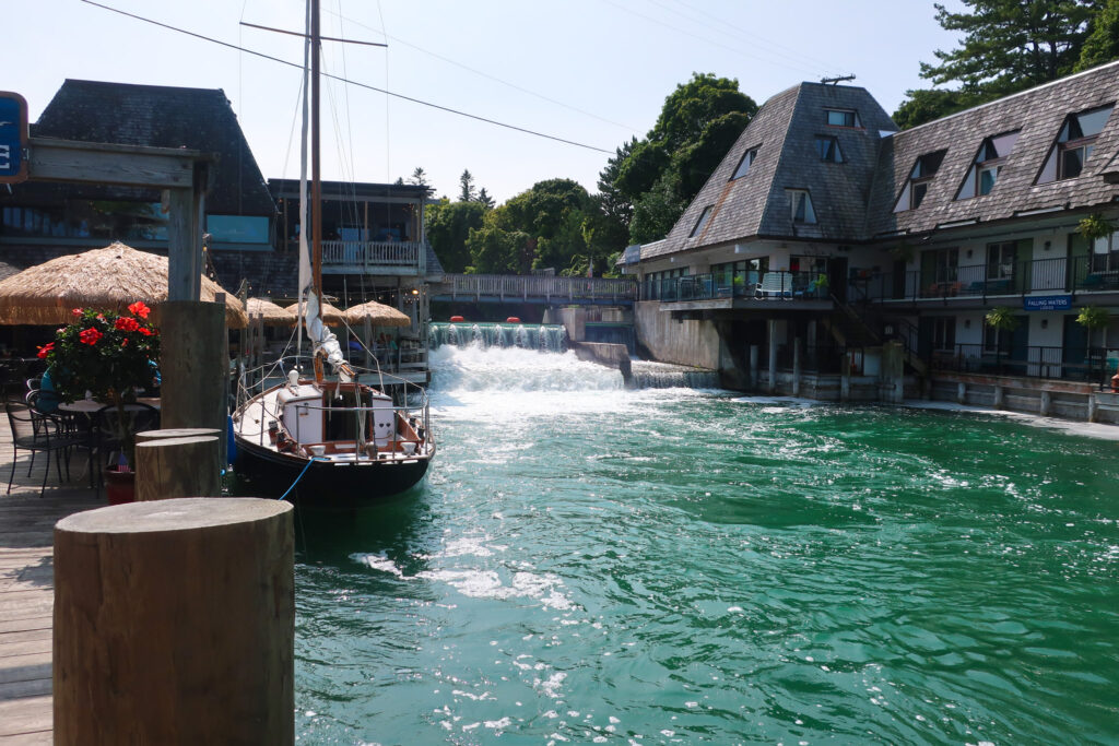 northern michigan; michigan roadtrip; mother daughter roadtrip; michigan summer; great lakes USA; leland michigan; fishtown michigan; woman near boat on water in michigan; dam in leland michigan