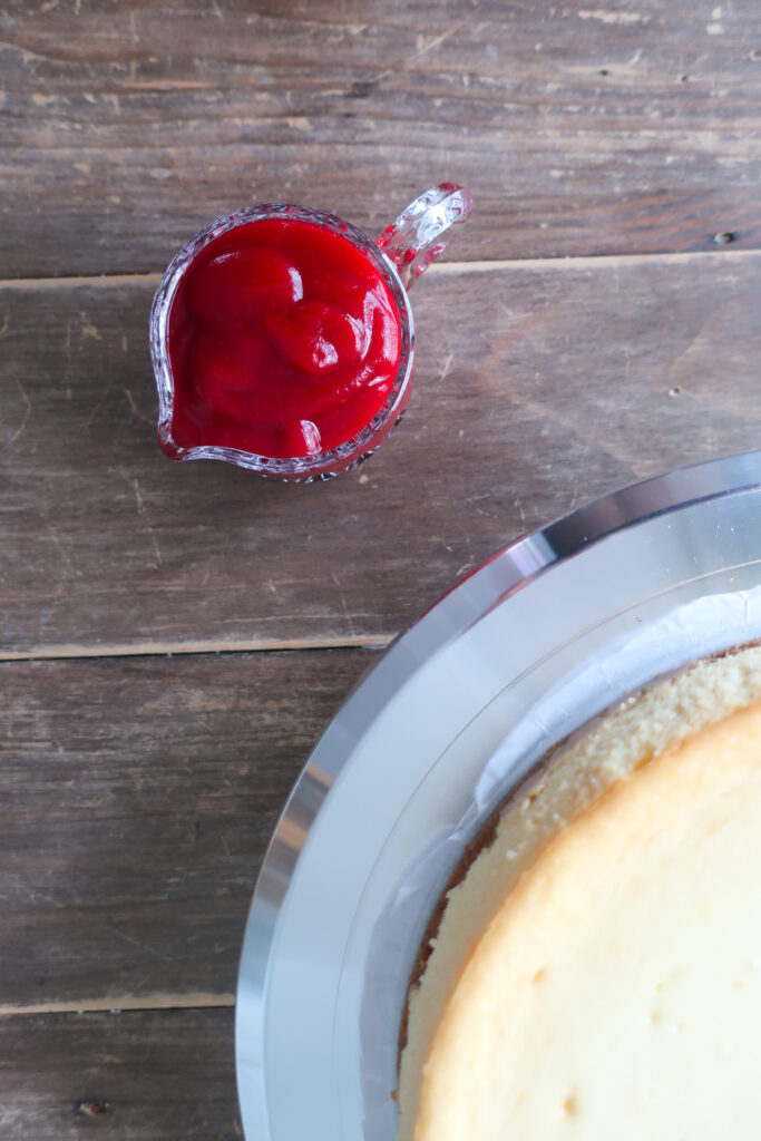 close up of cranberry sauce; orange cheesecake with cinnamon spiced graham cracker crust and topped with cranberry sauce