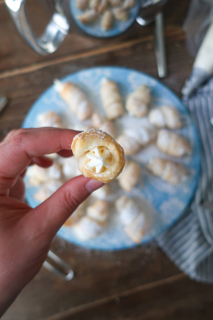 up close lady lock puff pastry filled with cream frosting