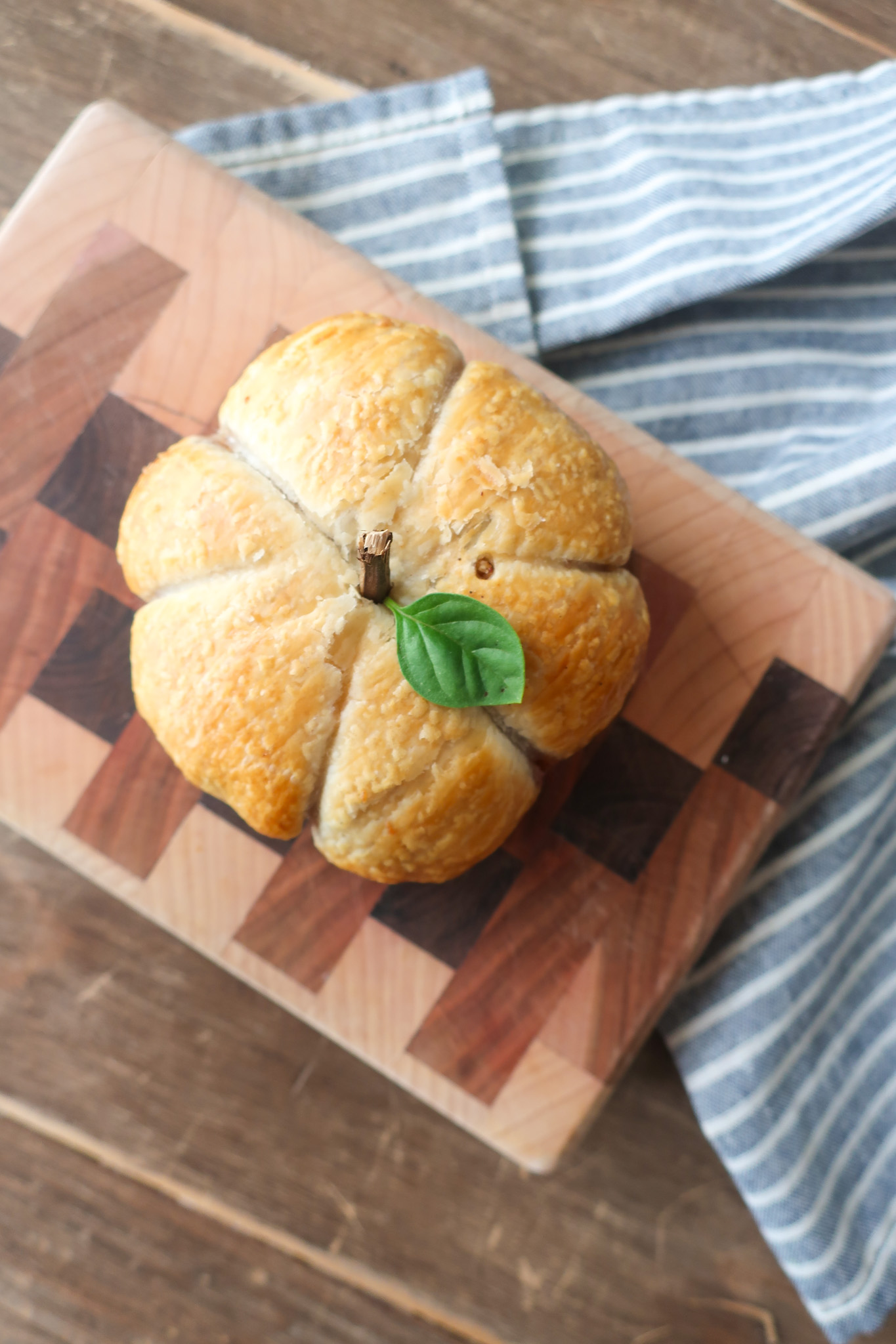 apple puff pastry shaped like pumpkins with basil leaves for pumpkin stems