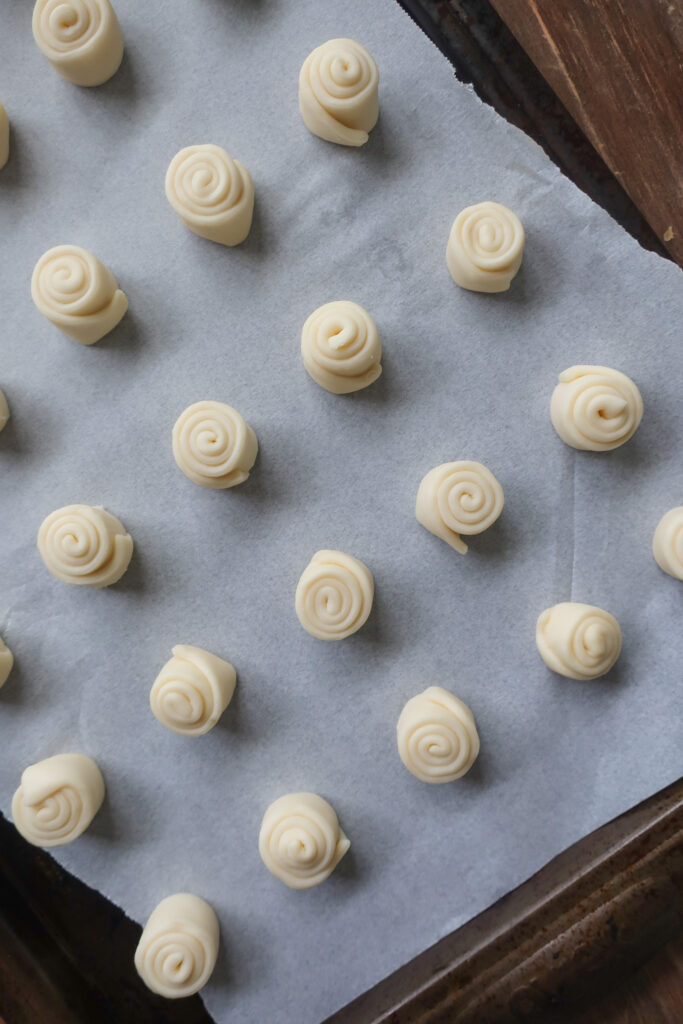 uncooked mini cinnamon swirl puff pastry on baking sheet