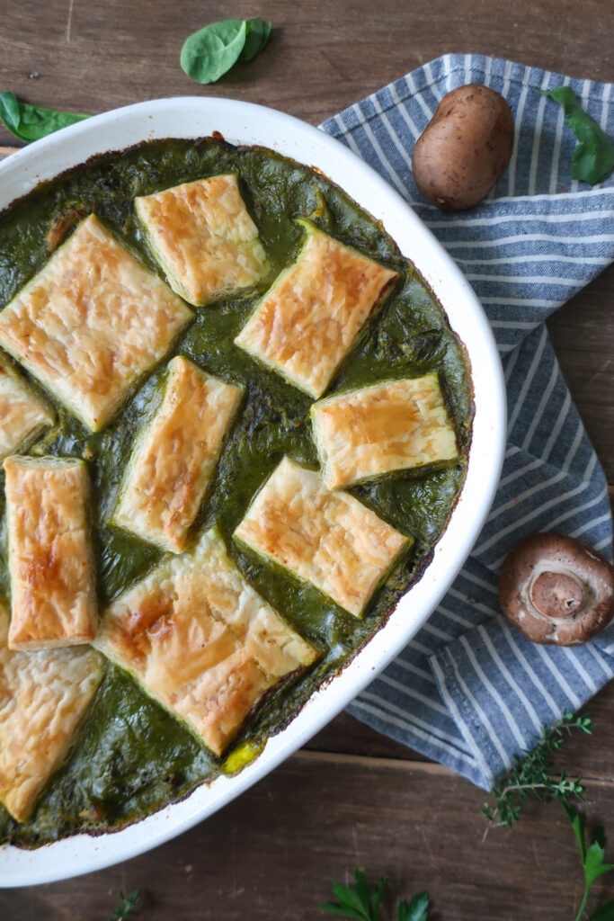 spinach and mushroom chicken pot pie topped with puff pastry