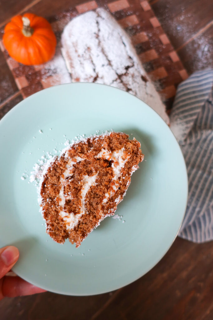 slice of pumpkin cake roll with whipped cream cheese frosting