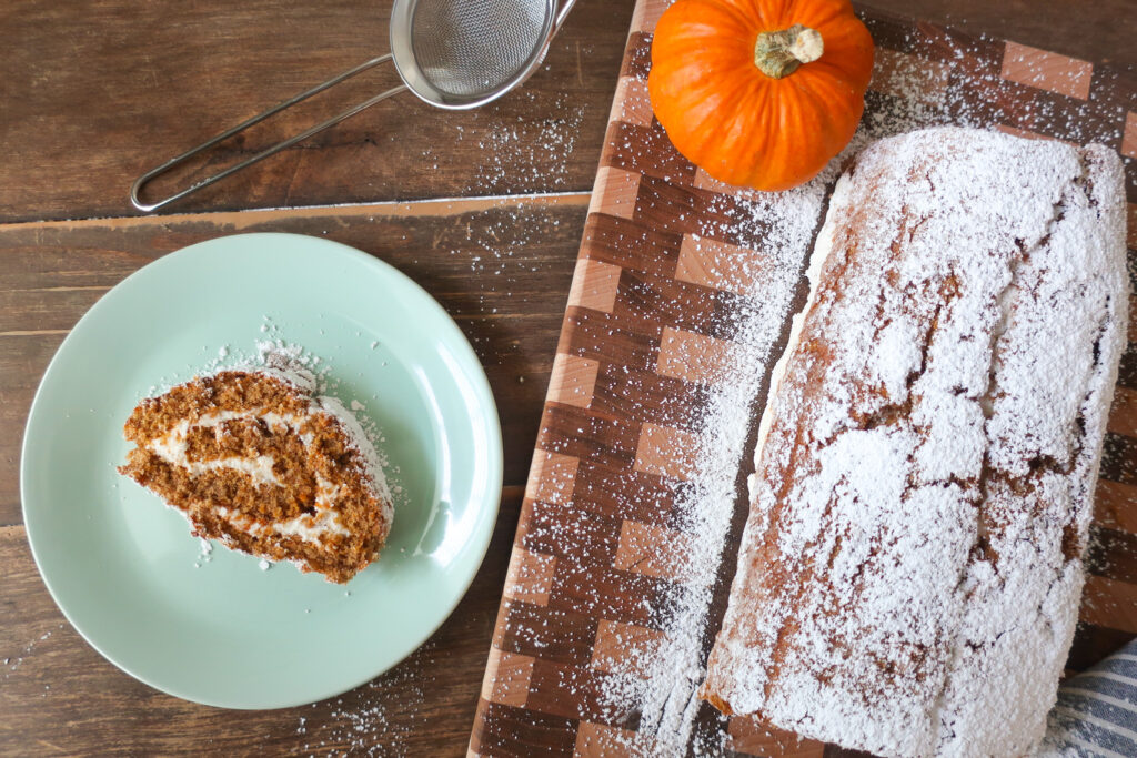 slice of pumpkin cake roll with whipped cream cheese frosting