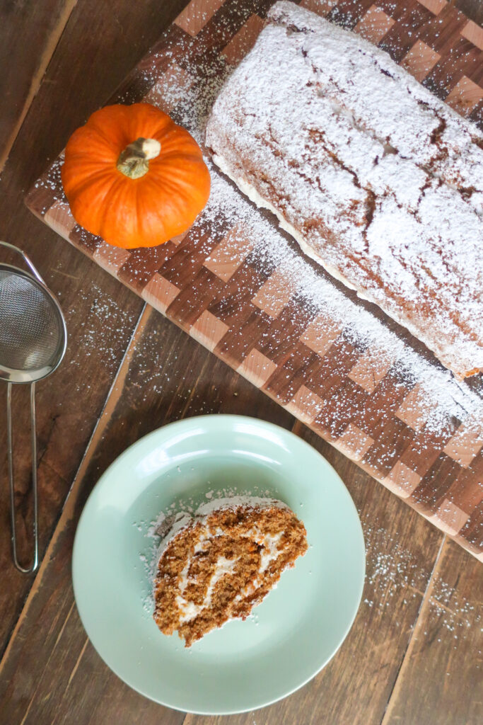 slice of pumpkin cake roll with whipped cream cheese frosting