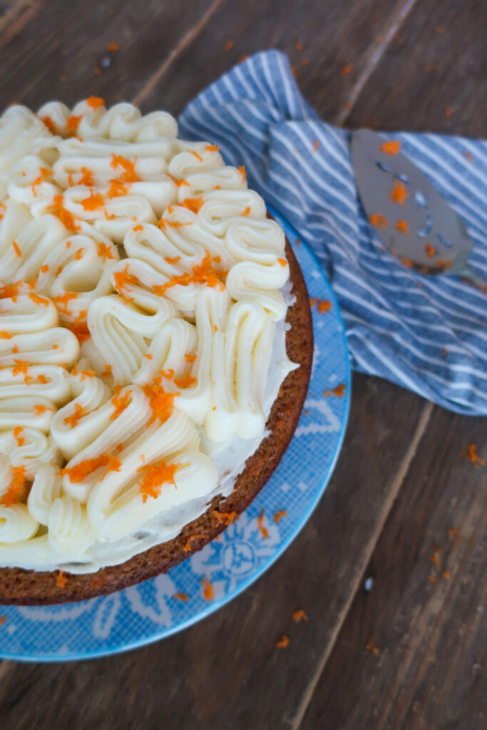 decorated nut and fruit free carrot cake with brown butter cream cheese frosting