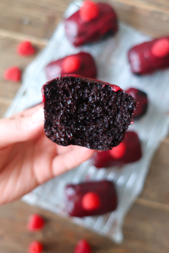 mini chocolate cakes with raspberry glaze topped with a single raspberry