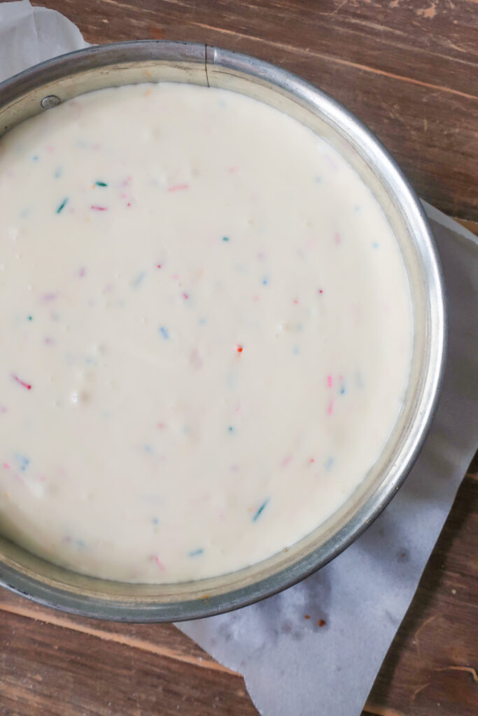 funfetti filling before baking; sprinkle shortbread crust; Funfetti cheesecake with shortbread crust