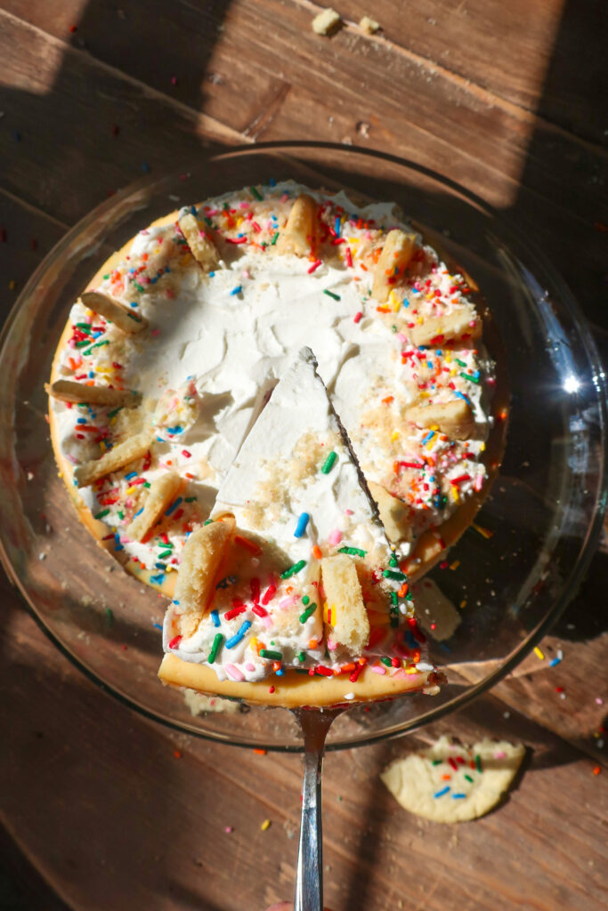 slice of Funfetti cheesecake with shortbread crust