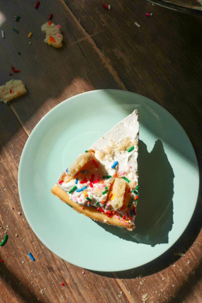 slice of Funfetti cheesecake with shortbread crust