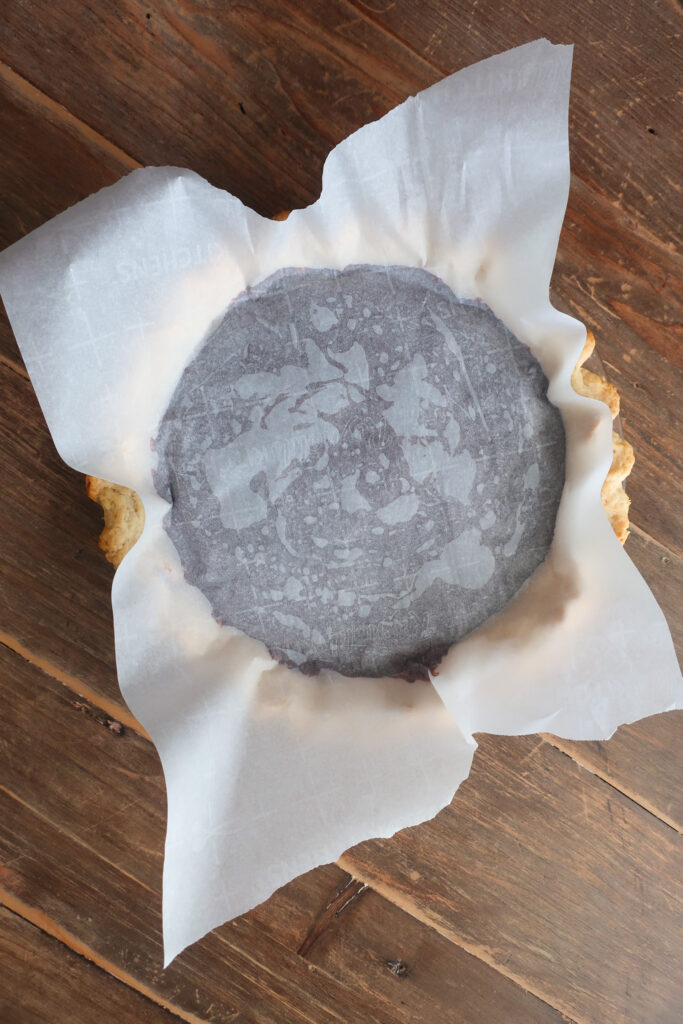 chocolate pudding pie filled with parchment paper pressed onto pudding to prevent skin from forming when pudding sets