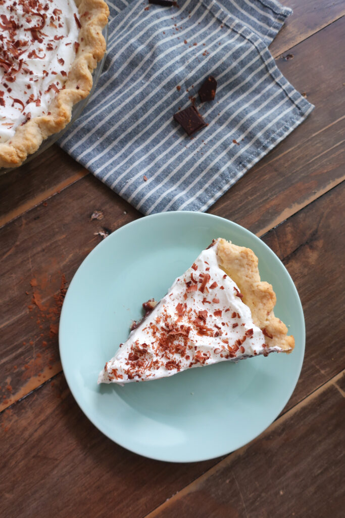 slice of chocolate pudding pie with whipped cream topping