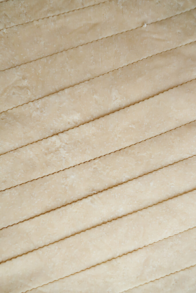 close up shot of lattice pie crust dough strips