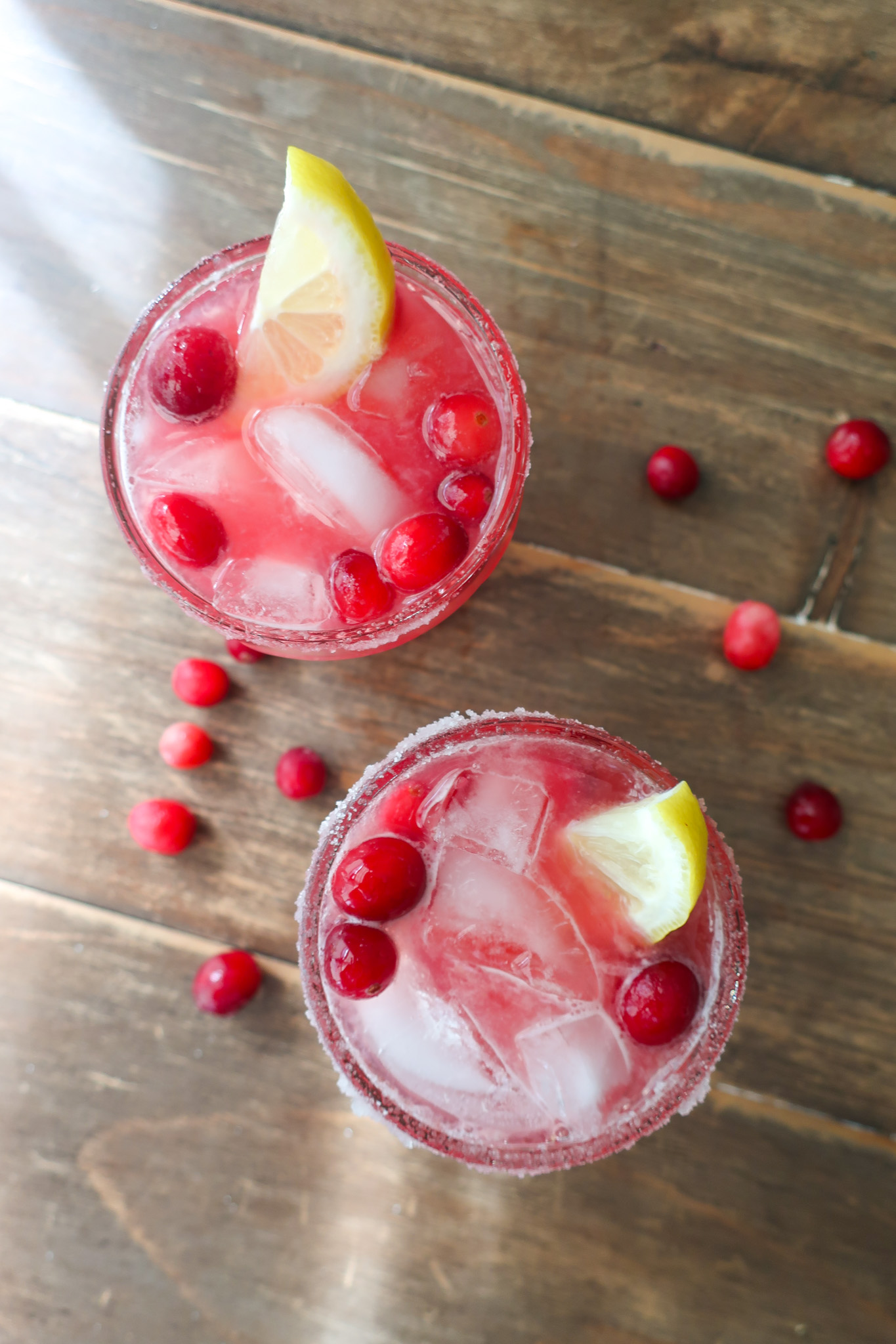 cranberry ginger mocktail topped with lemon slices and cranberries