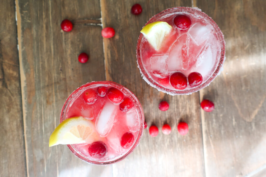 cranberry ginger mocktail topped with lemon slices and cranberries