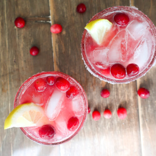 cranberry ginger mocktail topped with lemon slices and cranberries