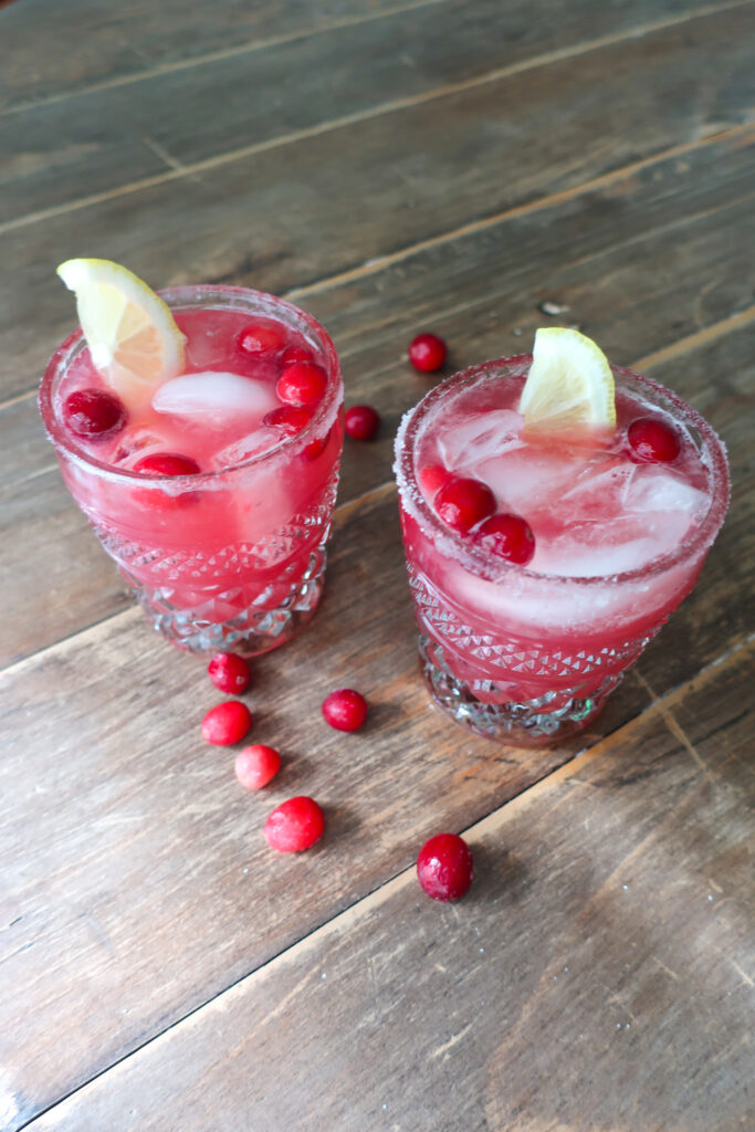 cranberry ginger mocktail topped with lemon slices and cranberries