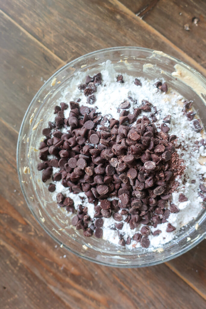 dry ingredients and chocolate chips in mixing bowl for peanut butter and chocolate chip cookie cake