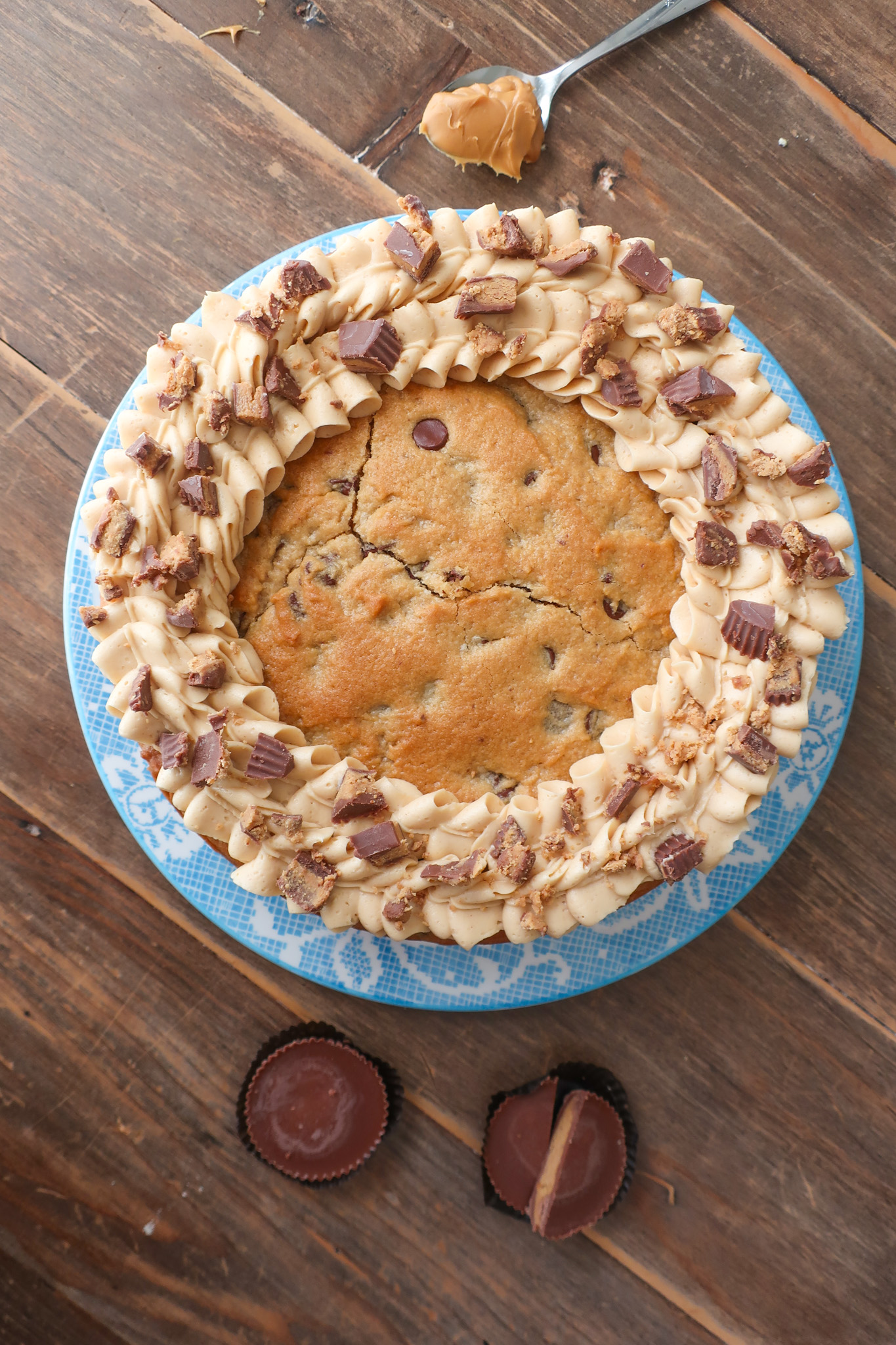 peanut butter and chocolate chip cookie cake with peanut butter buttercream frosting